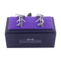 The Golf Swing Cufflinks elegantly rest on a purple velvet box labeled "AusCufflinks," showcasing a style that adds a touch of drive to any outfit.