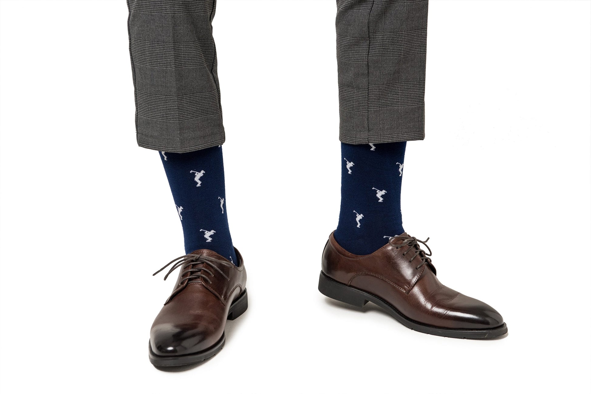 A pair of legs wearing brown shoes and Golf Swing Socks.