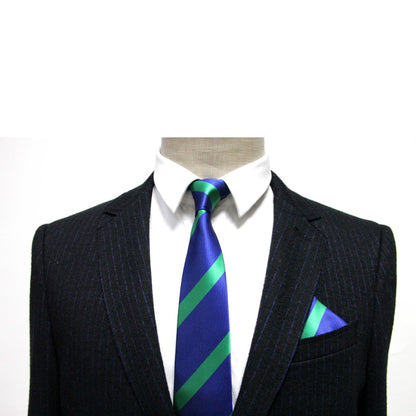 A mannequin displays a dark pinstripe suit and white shirt, paired with a blue tie and accessorized by a Navy Green Stripe Pocket Square, adding sophistication.