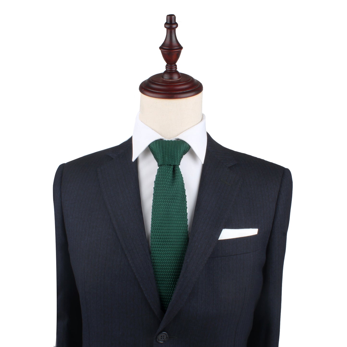 A tailored dark suit with a white dress shirt and a Green Knit Tie, exuding elegance, displayed on a mannequin bust.