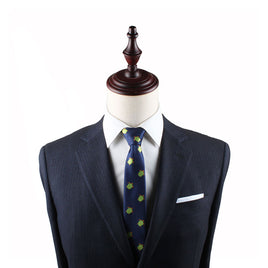 A mannequin dressed in a dark suit, Green Turtle Slim Tie, and white pocket square exuding natural elegance against a plain background.
