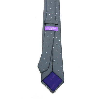 The Grey White Polka Dot Business Tie & Pocket Square Set, featuring a purple inner lining, adds a touch of magic and is complemented by the "Aristocrats" label.