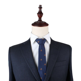 A mannequin dressed in a dark pinstripe suit, white shirt, and the Grizzly Bear Slim Tie exudes sophistication against a plain background, capturing an untamed allure.