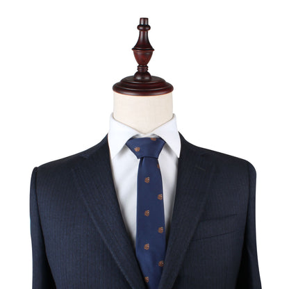 A mannequin dressed in a dark pinstripe suit, white shirt, and the Grizzly Bear Slim Tie exudes sophistication against a plain background, capturing an untamed allure.