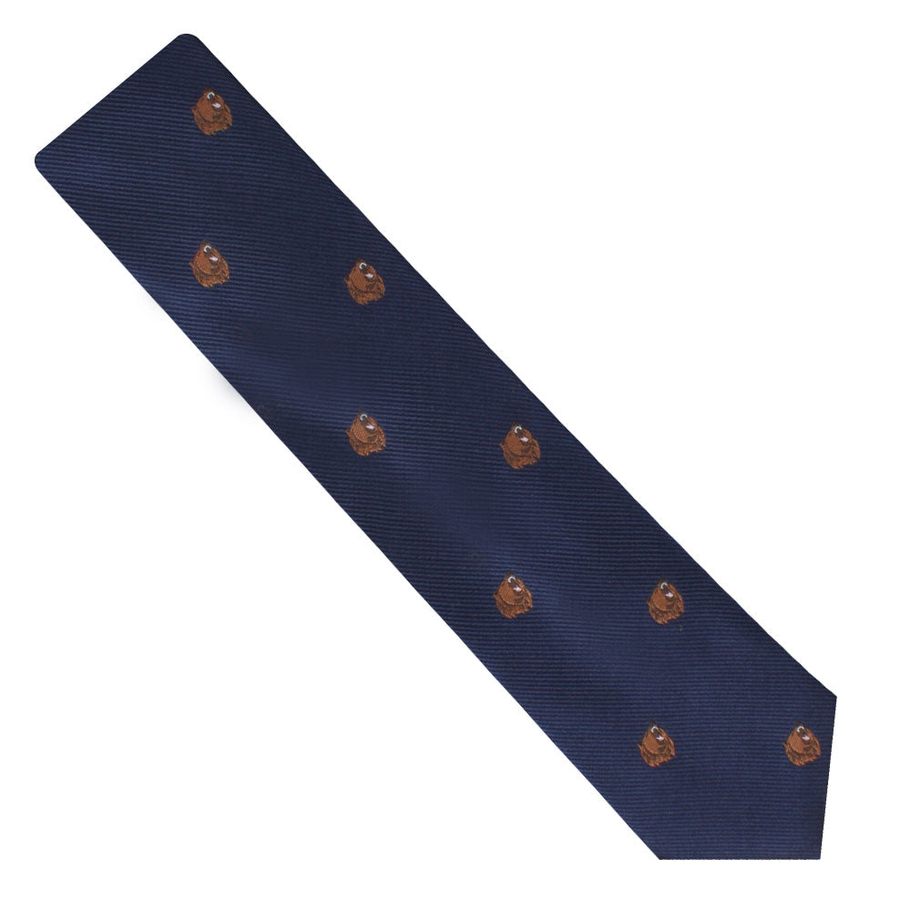 The Grizzly Bear Thin Tie adds a touch of sophistication with its navy blue color and charming pattern of small Grizzly bear faces.