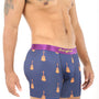 A man stands against a white background, mimicking guitar playing while wearing Guitar Underwear, which features a guitar pattern on blue boxer briefs with a purple waistband, effortlessly combining style and comfort.