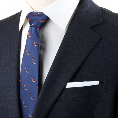 Close-up of a person wearing a dark pinstripe suit, white dress shirt, and blue Field Hockey Skinny Tie. A white pocket square is visible in the chest pocket, subtly reflecting an athletic spirit.