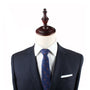 Mannequin dressed in a dark suit with a white shirt, Ice Hockey Slim Tie, and a white pocket square, exuding timeless allure.