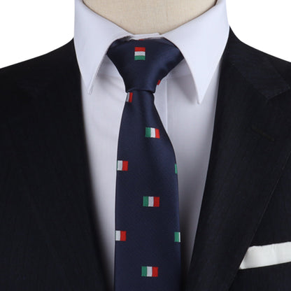 A person in a dark suit and white shirt is accented by the Mexican Italian Flag Skinny Tie, featuring red, green, and white square patterns.