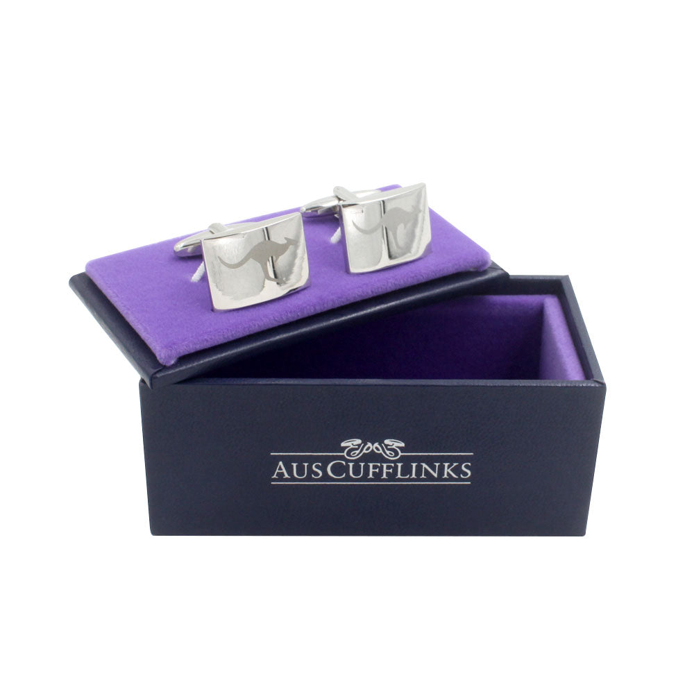 A pair of Silver Kangaroo Cufflinks displayed in an open dark blue box lined with purple fabric, labeled "AUS CUFFLINKS," showcasing Australian elegance.