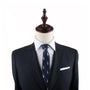 A mannequin dressed in a dark suit, white dress shirt, and the Kebab Slim Tie savor the essence of timeless elegance.
