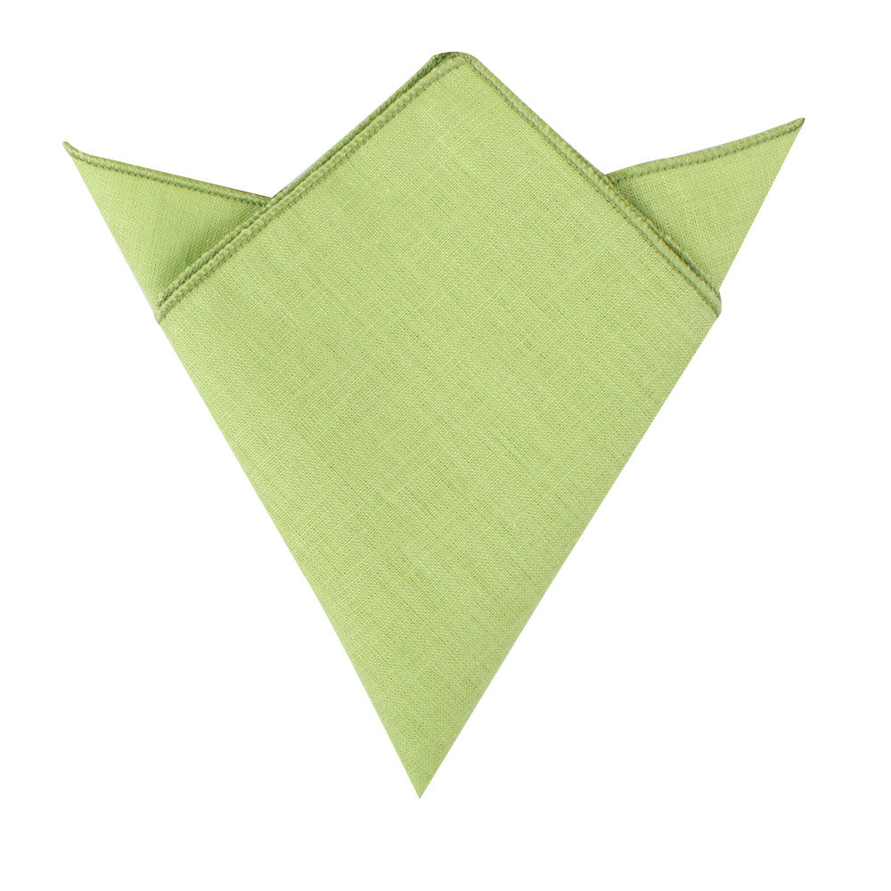 A neatly folded lime green pocket square with pointed edges, resembling an envelope or an arrowhead, showcasing a sharp silhouette from the Lime Green Cotton Skinny Tie & Pocket Square Set.