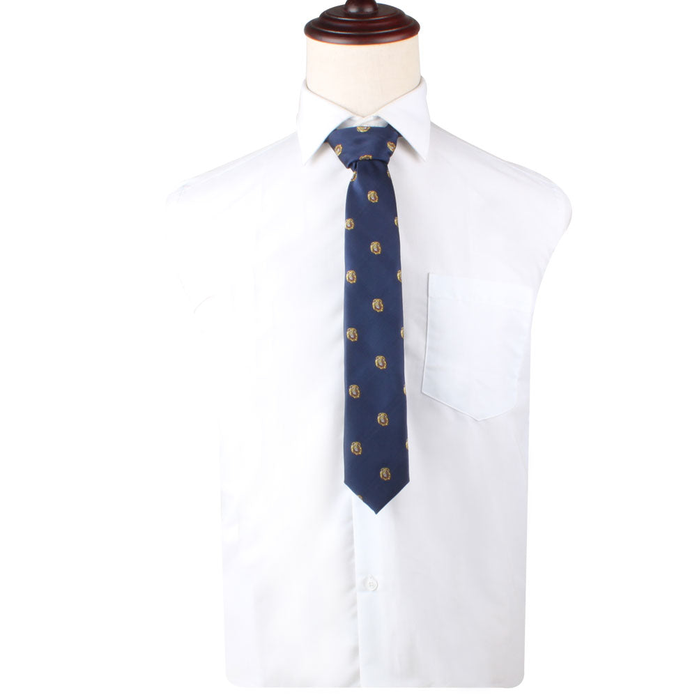 A white dress shirt featuring a front pocket and a King Lion Skinny Tie, adorned with a repeating lion motif symbolizing leadership and courage, displayed on a dress form.