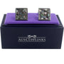 A pair of Signature Malachite Cufflinks with a stellar mosaic design, presented on a purple cushion inside an "auscufflinks" branded box.