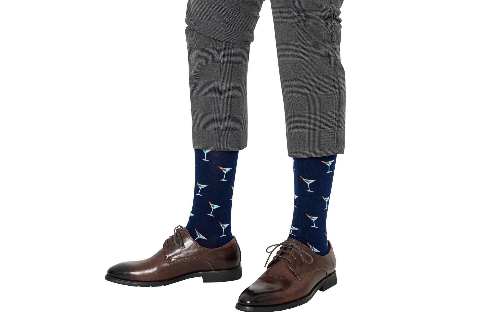 A person elevates their sock game by wearing Martini Margarita Socks with cocktail glass designs, paired perfectly with gray plaid pants and brown dress shoes.
