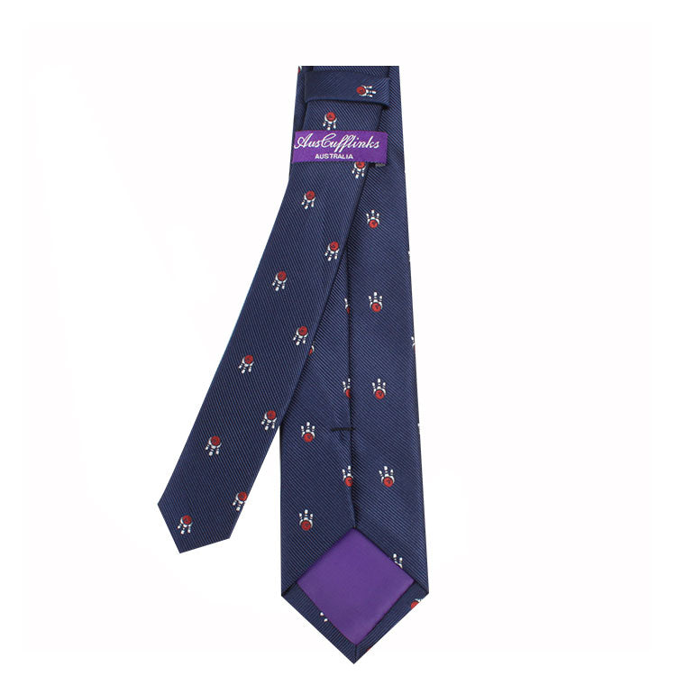 The Men's Bowling Tie, featuring a navy blue background adorned with small red and white circular patterns and displaying the "Italy inlands" label, perfectly harmonizes leisure and style.