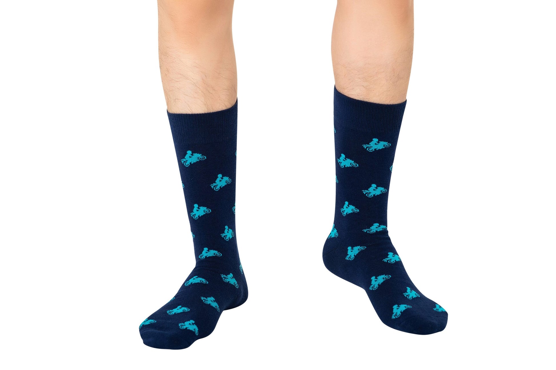 Person showcasing navy blue knee-high Motorbike Socks with a turquoise bicycle pattern, perfectly complementing their stylish footwear.