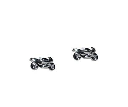 Enhance your style with these silver motorbike cufflinks, showcasing shiny details that catch the light against a sleek white backdrop.