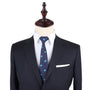A dark pinstripe suit jacket, white dress shirt, and Motorbike Slim Tie displayed on a mannequin exude a sense of boldness.