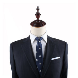 A mannequin dressed in a dark suit jacket, white shirt, and the Mushrooms Slim Tie exudes elegance against the plain white background.