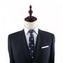 A mannequin dressed in a dark suit jacket, white shirt, and the Mushrooms Slim Tie exudes elegance against the plain white background.