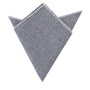 A Navy Blue Herringbone Pocket Square, meticulously arranged in a triangular fold, exuding elegance.