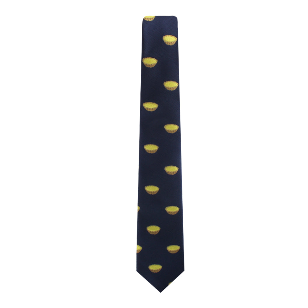 The Egg Tart Skinny Tie is a delightful dark blue accessory, adorned with a charming pattern of small, yellow pie illustrations—ideal for anyone with a taste for pastry-inspired fashion.