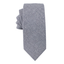 A neatly folded, Navy Blue Herringbone Skinny Cotton Tie Tie exudes sophistication.