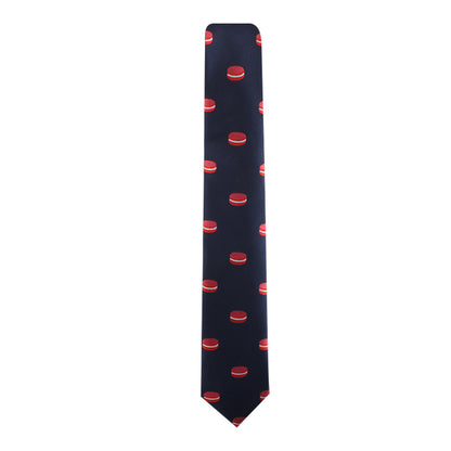 Presenting the Macaron Skinny Tie, ideal for dessert aficionados. This navy tie displays a pattern of red macarons, elegantly spaced, merging gourmet dessert charm with fashion-forward style.
