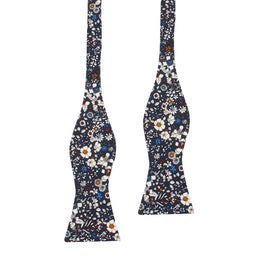 The Navy Multi Floral Self Tie Bow Tie features an elegant navy background with white, orange, and blue flowers—a perfect choice for weddings.