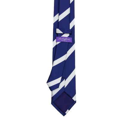 The Navy White Stripe Business Tie & Pocket Square Set features a navy tie with diagonal white stripes and a purple label on the back, ideal for formal occasions. Pair it with the matching pocket square for a polished business look.
