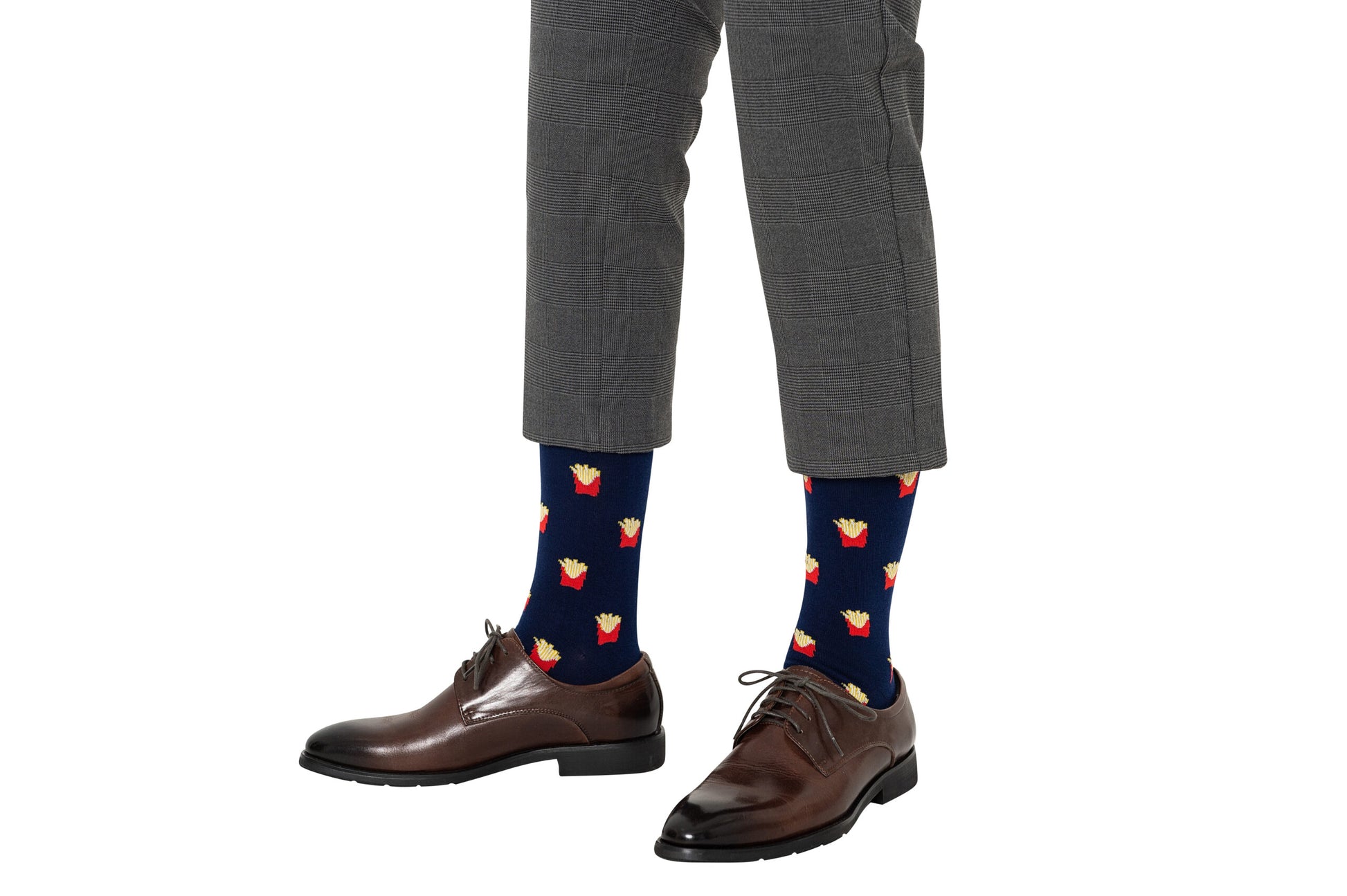 A person wearing gray plaid pants, brown dress shoes, and Fries Socks with a realistic navy blue fries print.