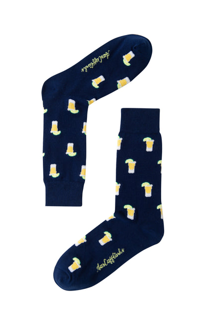 A pair of Tequila Socks in navy blue with a repeating beer mug pattern and yellow cursive text on the soles—ideal for tequila lovers.