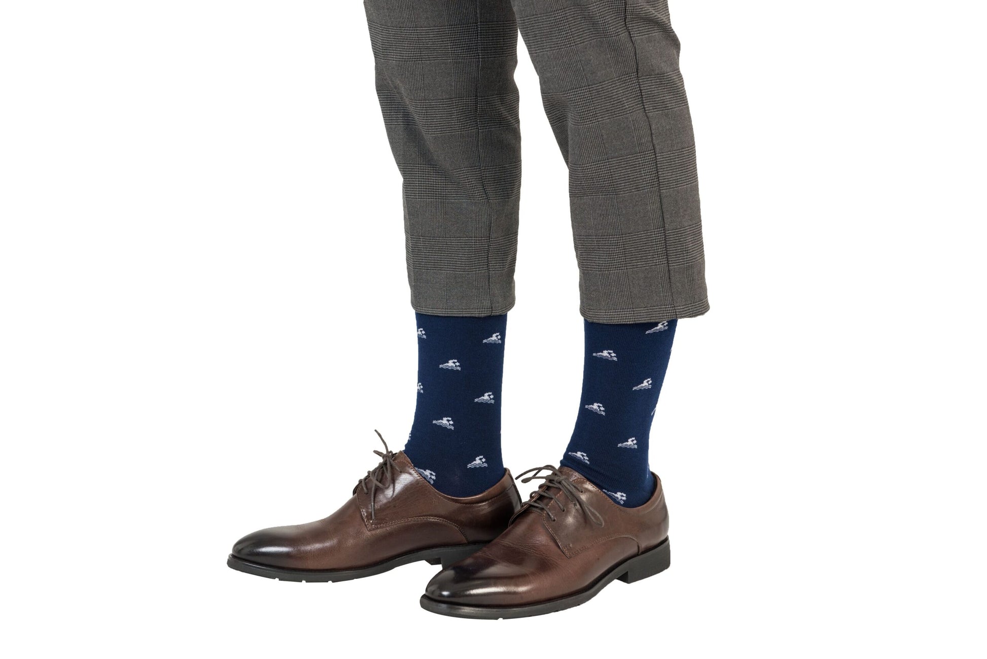 A person exhibits a coastal-inspired look, sporting Swimming Socks with a white pattern and brown leather shoes, paired with gray plaid pants.