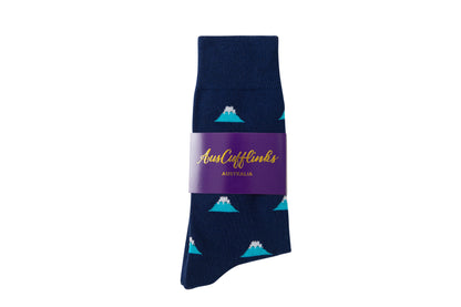 A single Mountain Sock in navy blue, featuring a pattern of white-topped mountains and valleys, packaged with a purple label reading "AusCufflinks Australia.