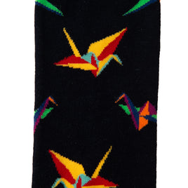 The Paper Bird Socks are black and present a vibrant pattern of origami cranes in red, yellow, green, and blue, displaying intricate craftsmanship in every detail.