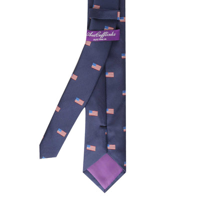 The Patriotic Skinny Tie in navy blue, adorned with mini U.S. flag motifs, exudes patriotism, and a purple label that reads "AusCufflinks Australia" enhances its stylishness.