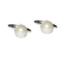 The Pearl Silver Cufflinks, with their spherical pearl-like tops and sleek silver bands, elegantly enhance any outfit, making them ideal for a formal style against a crisp white backdrop.
