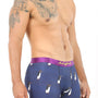 A man wearing Penguin Underwear, featuring a penguin design and a purple waistband, exudes polar comfort as he stands in a studio setting.