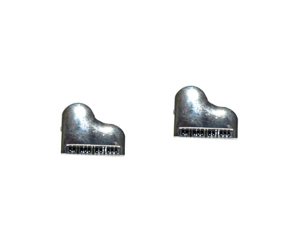 Two small, metallic Piano Music Cufflinks create a style symphony on a white background.