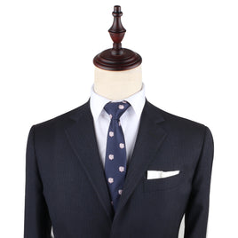 A mannequin dressed in a dark suit jacket, white dress shirt, and a Piggy Bank Slim Tie showcases formal menswear, exuding sophistication. Perfect for those looking to invest in standout attire.