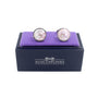 A pair of Pink Crystal Dome Cufflinks, featuring a round mosaic pattern and exuding crystalline grace, are displayed on a purple cushion, housed in a navy blue box labeled "AusCufflinks.