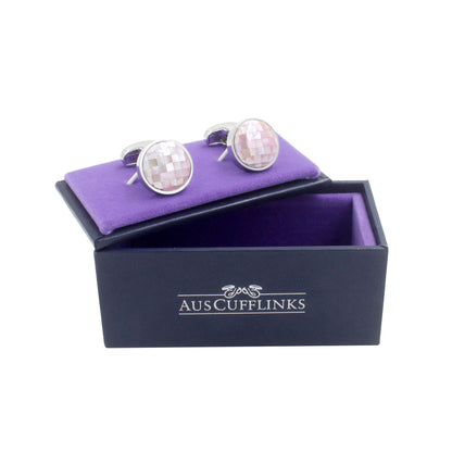 A pair of Pink Crystal Dome Cufflinks, radiating style and grace, sits on a purple velvet display inside an open black box labeled "AUSCUFFLINKS".