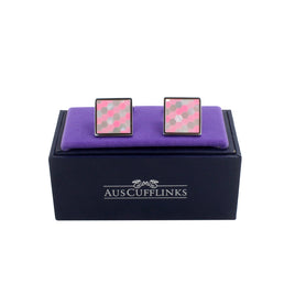 The Pink Crystal Mosaic Cufflinks feature a pink hexagonal pattern, exuding artful elegance on a purple velvet display, presented in a black box labeled "Auscufflinks.