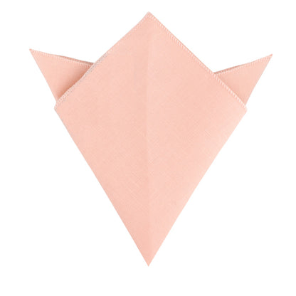 A folded Baby Pink Skinny Necktie and Pocket Square Set with pointed edges, resembling a triangular shape, is displayed against a white background, exuding pastel sophistication.