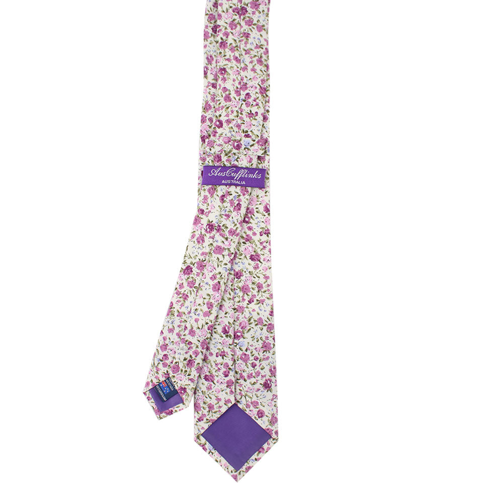 The Pink Roses Floral Cotton Skinny Tie and Pocket Square Set exudes timeless charm, showcasing a floral pattern with a complementary lining at the tip.