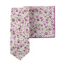 The Pink Roses Floral Cotton Skinny Tie and Pocket Square Set showcases a perennial charm with its blush blooms and purple flowers against a crisp white background.