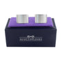 A pair of Plain Silver Cufflinks, embodying subtle sophistication, displayed on a purple cushion inside a navy blue box labeled "AUSCUFFLINKS.