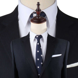 Mannequins dressed in formal attire: one in a white dress shirt and dark suit with a Poker Cards Slim Tie, and another focused closely on a white dress shirt collar with a dark suit. Elevate your style with these polished looks that make an impression.