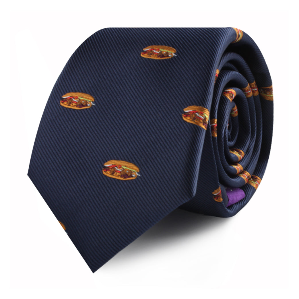 A rolled-up Pork Roll Slim Tie in navy blue, featuring a playful pattern of small hamburger images scattered across the fabric, adding a touch of modern charm inspired by comfort food.